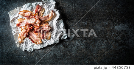 Top of view roasted bacon on paper. Top of view roasted bacon on paper. 44850753