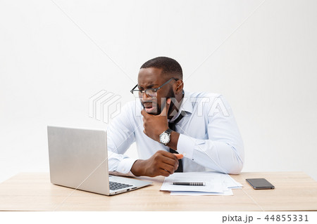Disappointed African businessman is dazed and confused by a mistake in official documents. He feels Disappointed African businessman is dazed and confused by a mistake in official documents. He feels 44855331