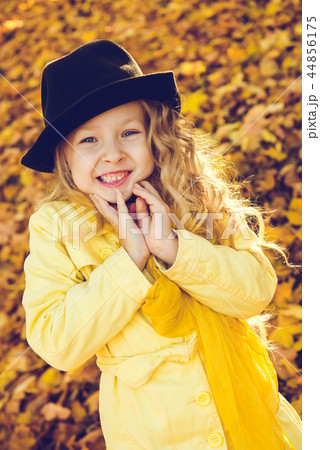 Little beautiful girl with blond hair in autumn background 44856175
