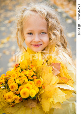 Little beautiful girl with blond hair in autumn background 44856254