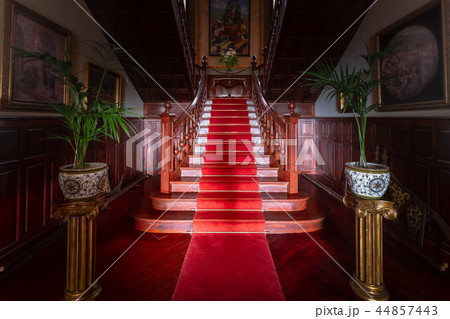 Red carpet on wooden stairs in old palace or manor Red carpet on wooden stairs in old palace or manor 44857443