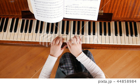 A baby hands playing piano on music lesson in school. Upper angle 44858984
