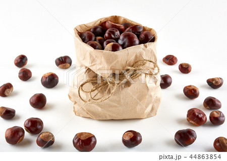 Chestnuts in paper bag on white background 44863854