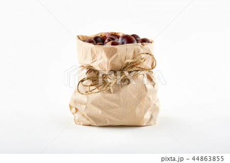 Chestnuts in paper bag on white background 44863855