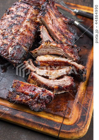 Barbecue Pork Spare Ribs as top view on a burnt cu Barbecue Pork Spare Ribs as top view on a burnt cu 44864990