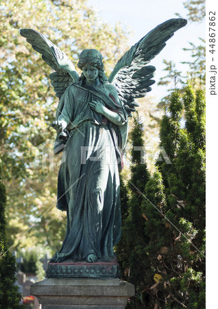 Closeup of bronze angel on tomb in cemetery 44867862