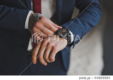 The man checks the time on the wristwatch 1584. The man checks the time on the wristwatch 1584. 44869984