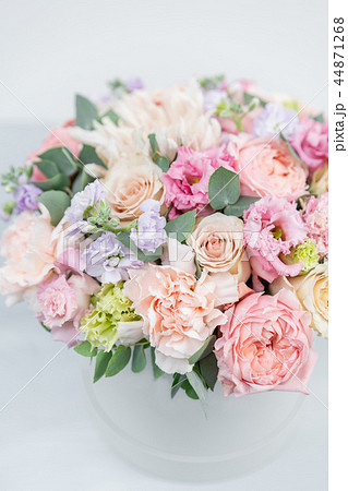 Beautiful spring bouquet in round box. Arrangement with various flowers. The concept of a flower Beautiful spring bouquet in round box. Arrangement with various flowers. The concept of a flower 44871268
