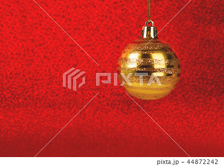 Christmas bauble on red glitter blurred background. 44872242