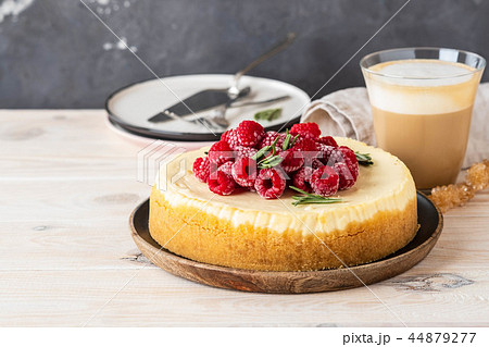 Vanilla New York cheesecake with raspberries and coffee with milk. Copy space. 44879277