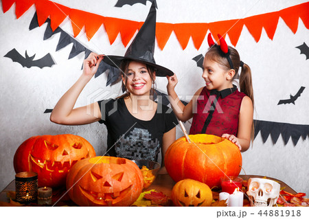 Funny Mother and daughter having fun at home. Happy family preparing for Halloween. People wearing Funny Mother and daughter having fun at home. Happy family preparing for Halloween. People wearing 44881918