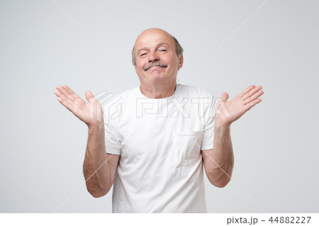 Puzzled bald caucasian man is not sure  44882227