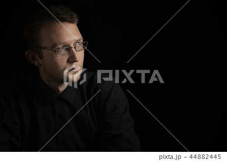 young man close up portrait, on black with glasses young man close up portrait, on black with glasses 44882445