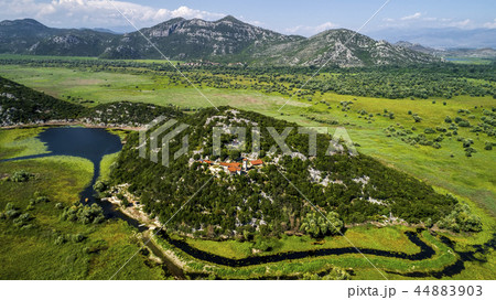 Aerial view of the landscape of Lake Skadar in the mountain and the island with monastery on a Aerial view of the landscape of Lake Skadar in the mountain and the island with monastery on a 44883903