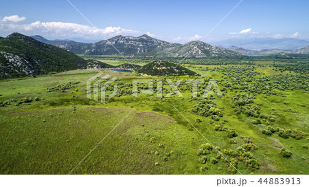 Aerial view of the landscape of Lake Skadar in the mountain and the island with monastery on a Aerial view of the landscape of Lake Skadar in the mountain and the island with monastery on a 44883913