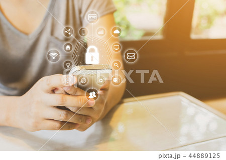 Woman using smartphone with cyber security network 44889125