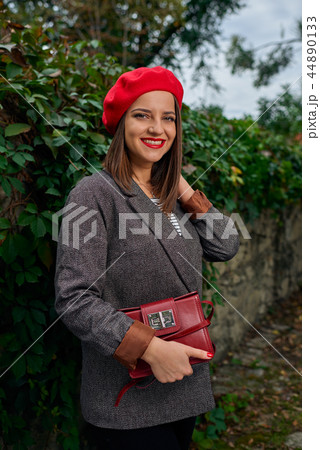 Holding red handbag. Holding red handbag. 44890133