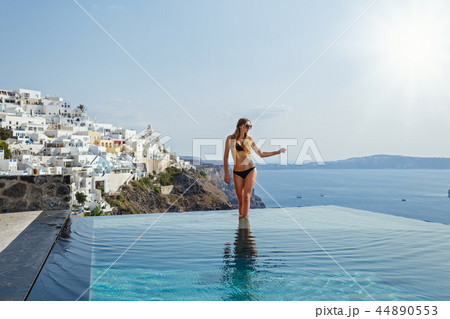 Beautiful woman in the pool 44890553