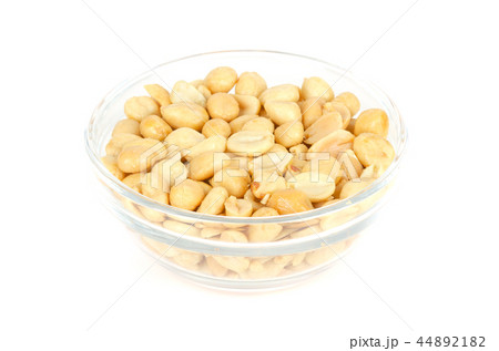 Roasted and salted peanuts in glass bowl over whit Roasted and salted peanuts in glass bowl over whit 44892182