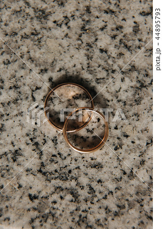Wedding rings on table. Gold rings with diamond on sun. Wedding accsessories. macro 44895793