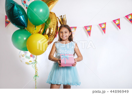 Portrait of a happy cute little kid holding gift box and looking at camera 44896949