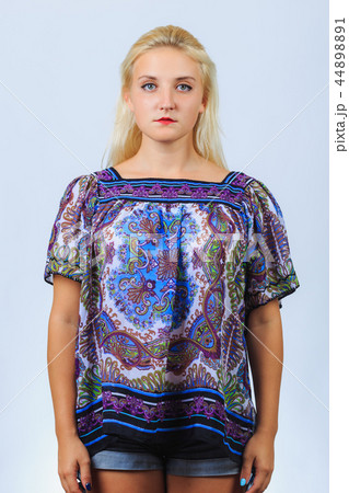 Young blonde girl stands straight 44898891