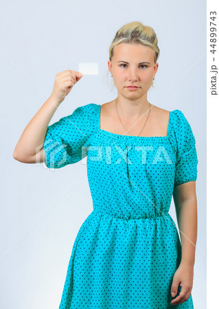 Young blonde girl holds business card 44899743