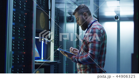 Man using laptop on mining farm in data center 44906325