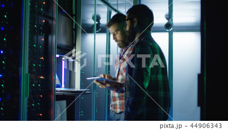 Coworking engineers setting mining farm hardware 44906343