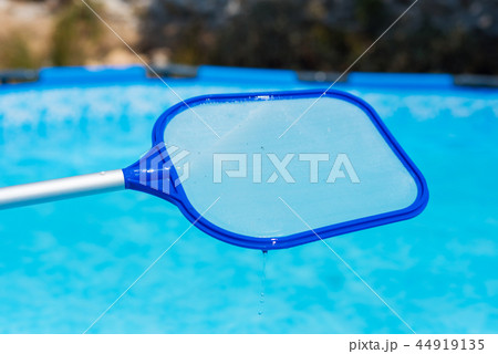 Backyard garden swimming pool cleaning close up Backyard garden swimming pool cleaning close up 44919135