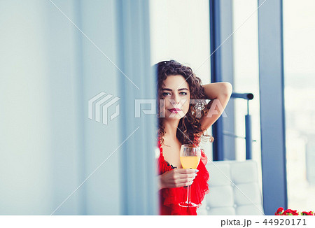 curly woman tasting wine 44920171