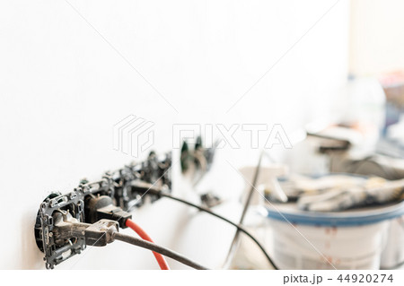 Work gloves in the foreground. Lots of tools and cans of paint in the background. Concept of repair Work gloves in the foreground. Lots of tools and cans of paint in the background. Concept of repair 44920274