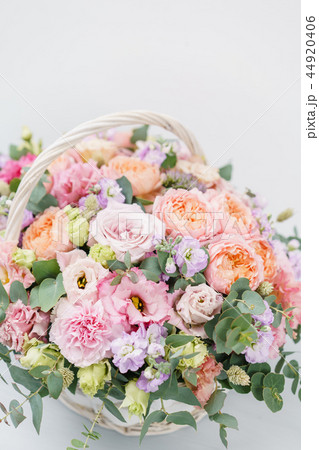 Beautiful spring bouquet in wicker basket. Arrangement with various flowers. The concept of a flower Beautiful spring bouquet in wicker basket. Arrangement with various flowers. The concept of a flower 44920406