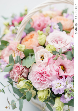Beautiful spring bouquet in wicker basket. Arrangement with various flowers. The concept of a flower Beautiful spring bouquet in wicker basket. Arrangement with various flowers. The concept of a flower 44920407