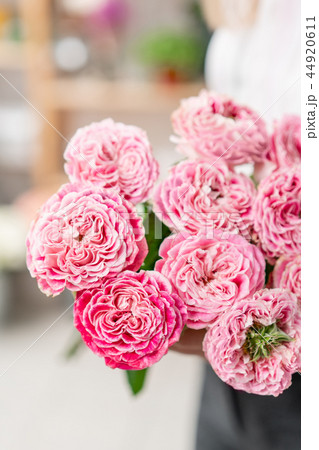 Garden roses bright pink and pastel colors. Bright bouquet in the hands of a cute girl. 44920611