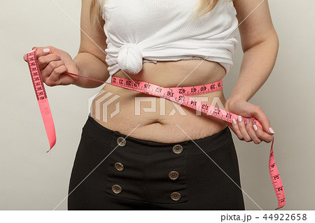 unrecognizable woman check her stomach fat 44922658