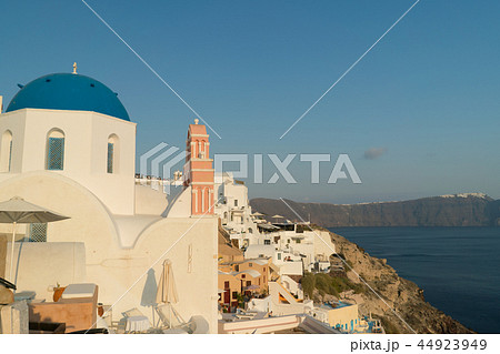 Oia town on Santorini island, Greece. Traditional and famous houses and churches with blue domes Oia town on Santorini island, Greece. Traditional and famous houses and churches with blue domes 44923949