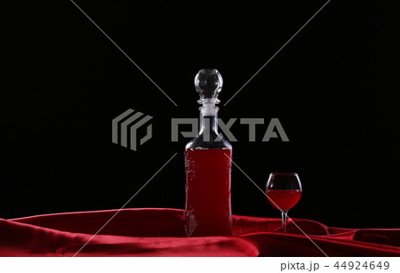 glass and bottle of wine on a dark background silk glass and bottle of wine on a dark background silk 44924649