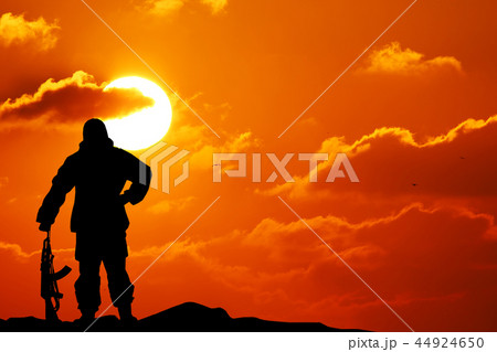 Silhouette shot of soldier holding gun 44924650