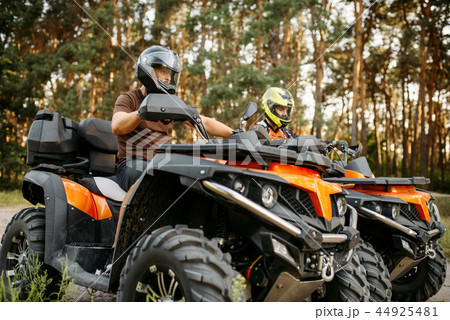 Two quad bike riders in helmets closeup, side view 44925481