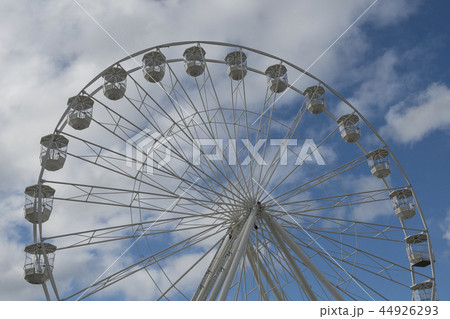 Part of a white ferris wheel on a blue sky Part of a white ferris wheel on a blue sky 44926293