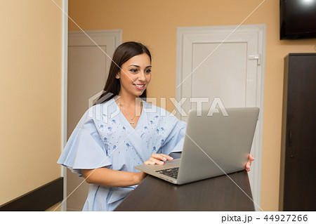 beutiful woman on reception working at laptop 44927266