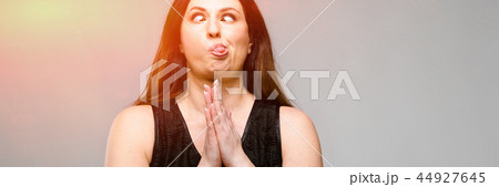Emotional smiling happy plus size model standing in studio looking in camera talking on phone with Emotional smiling happy plus size model standing in studio looking in camera talking on phone with 44927645