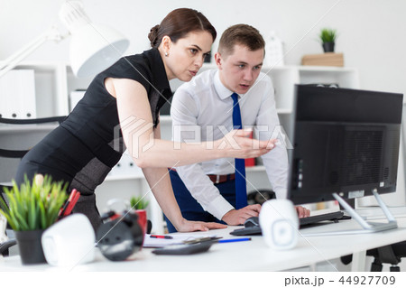 Young people in the office looking at the monitor. 44927709