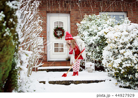 Child shoveling winter snow. Kids clear driveway. 44927929