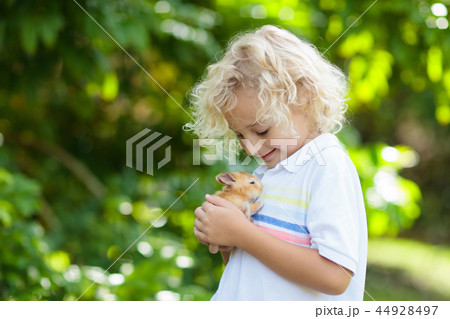 Child with rabbit. Easter bunny. Kids and pets. 44928497