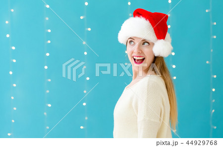 Happy woman with a Santa hat Happy woman with a Santa hat 44929768