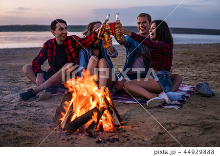 young friends have picnic with bonfire on the beach young friends have picnic with bonfire on the beach 44929888