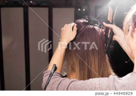hairdresser making a coiffure to a model hairdresser making a coiffure to a model 44940929