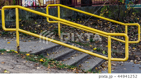 Yellow handrails near the stairs. cloudy days 44941252